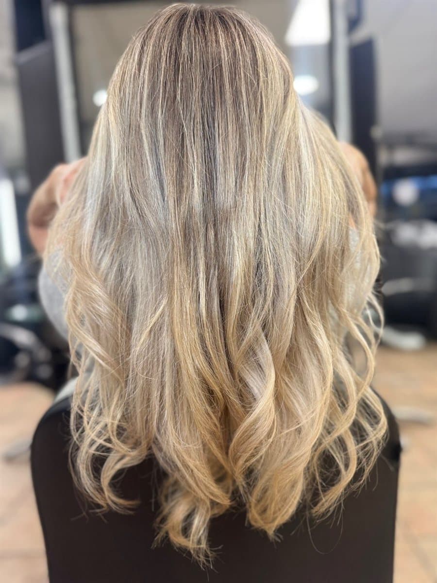Soft hand-painted blonde balayage with waves