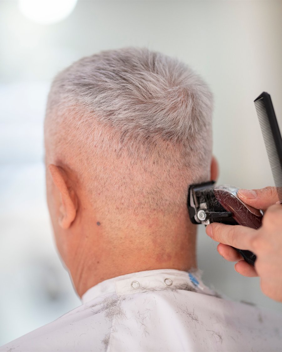An older gentleman having a clipper cut at Servanté Studio